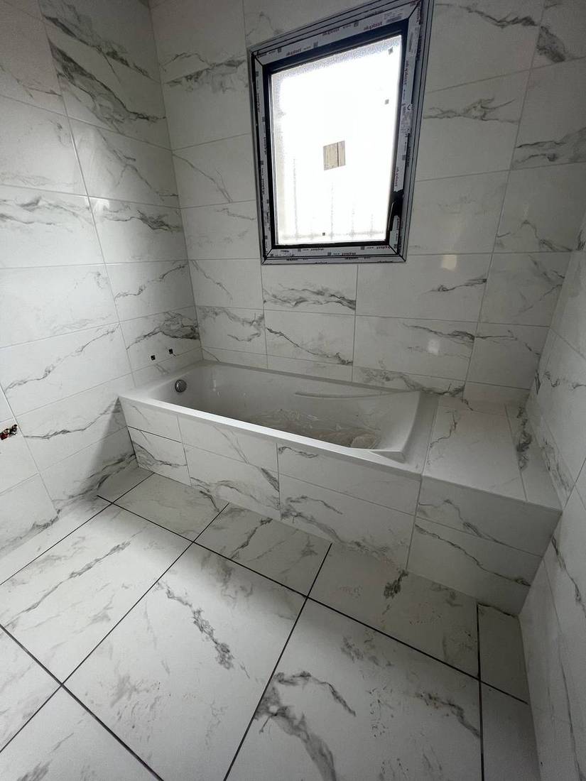 Salle de bains habillée de faïence effet marbre, réalisation Cigdemir Carrelage